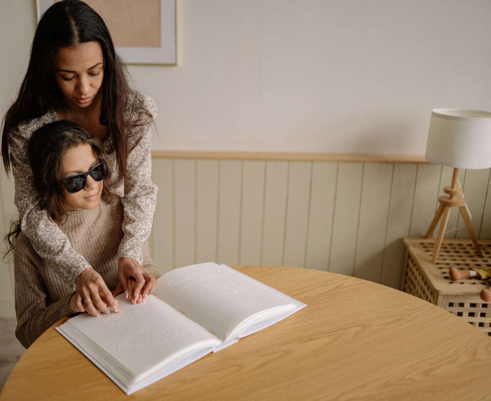 Teacher teaching girl braille