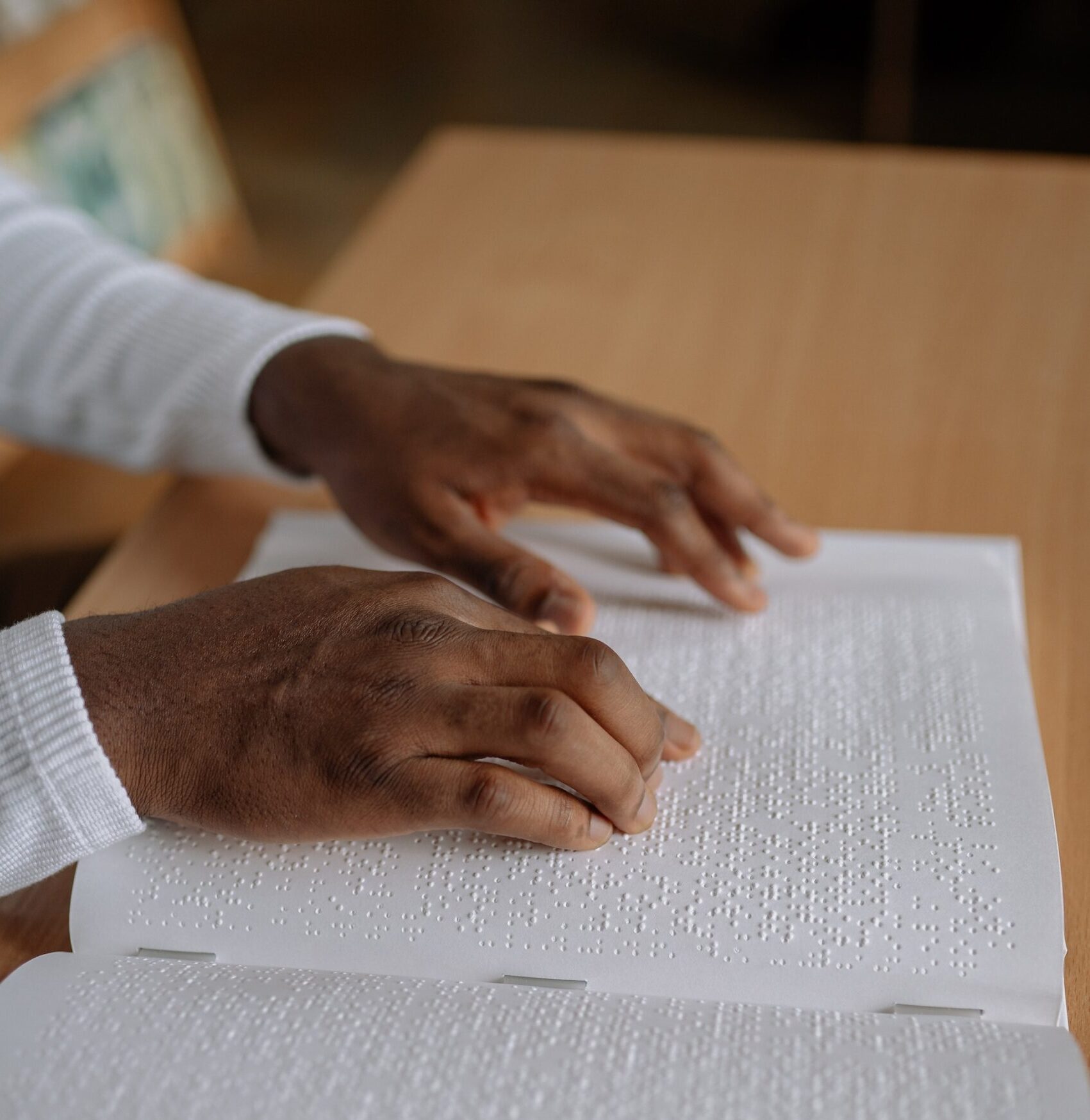 Hands reading braille